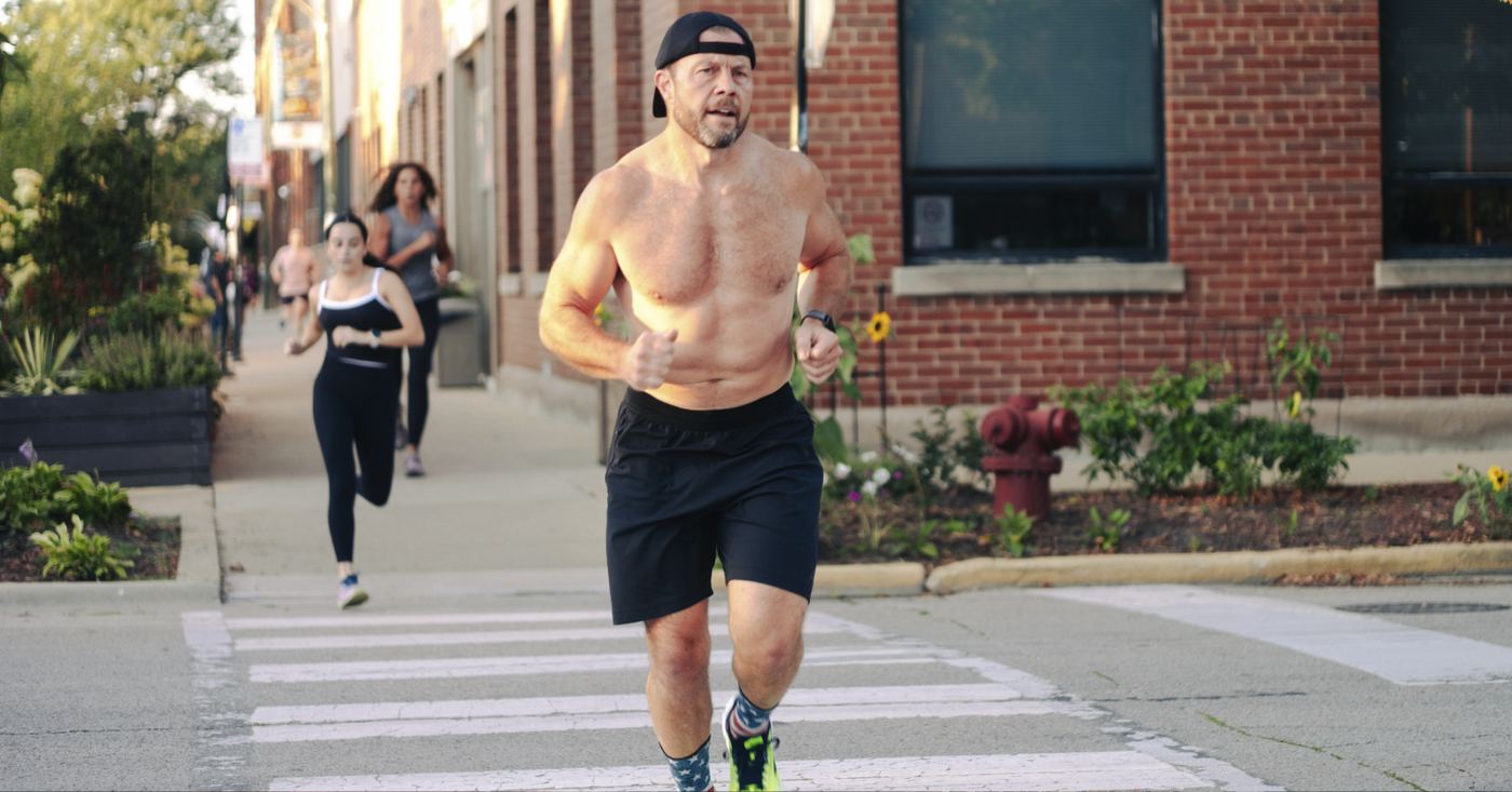 Members running down the sidewalk on Ravenswood during a workout